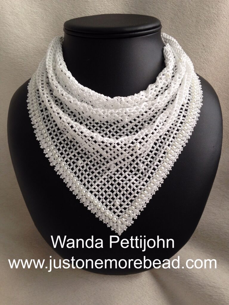 This scarf is made with a mix of #15 and #11 seed beads. Glass pearls and rondelles. The base is Right Angle Weave.  It has an elegant look to it and can be worn for most occasions. 